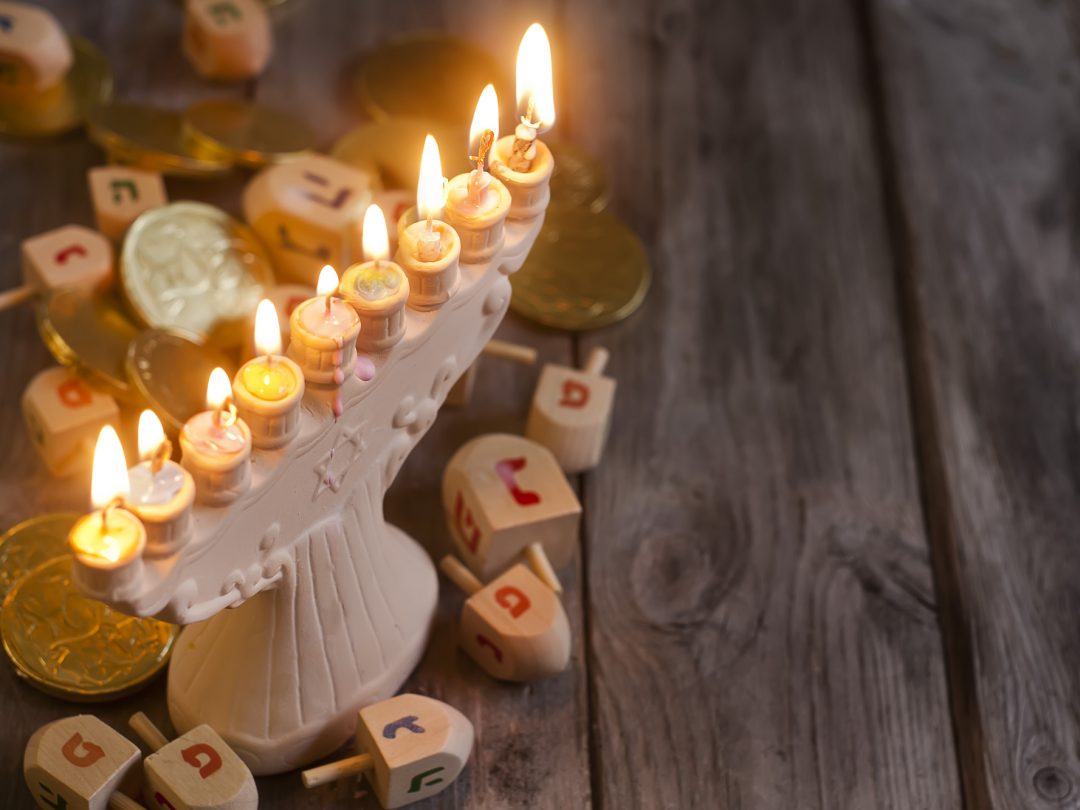 Jewish holiday hannukah symbols - menorah and wooden dreidels. C